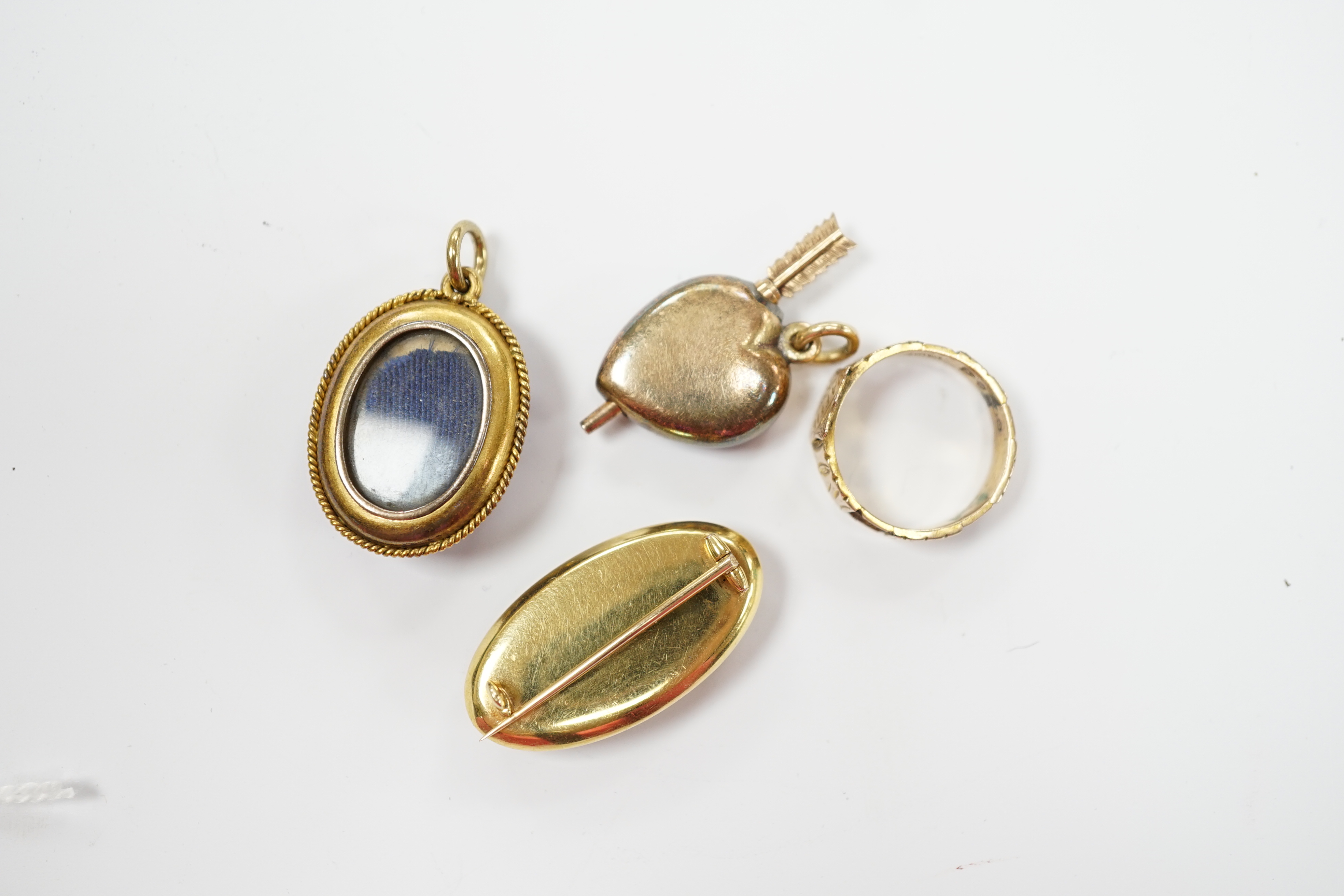 A Victorian yellow metal, blue enamel, seed pearl and rose cut diamond set oval pendant, with glazed back, 28mm, a late Victorian 9ct gold signet ring, engraved Mattie, a glazed yellow metal, enamel and seed pearl oval b